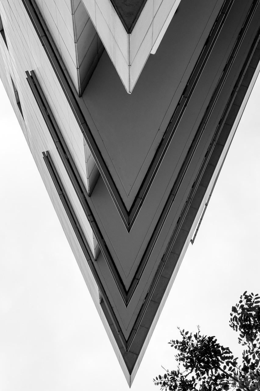 Angular glass building facade viewed from below, symbolising structure and order